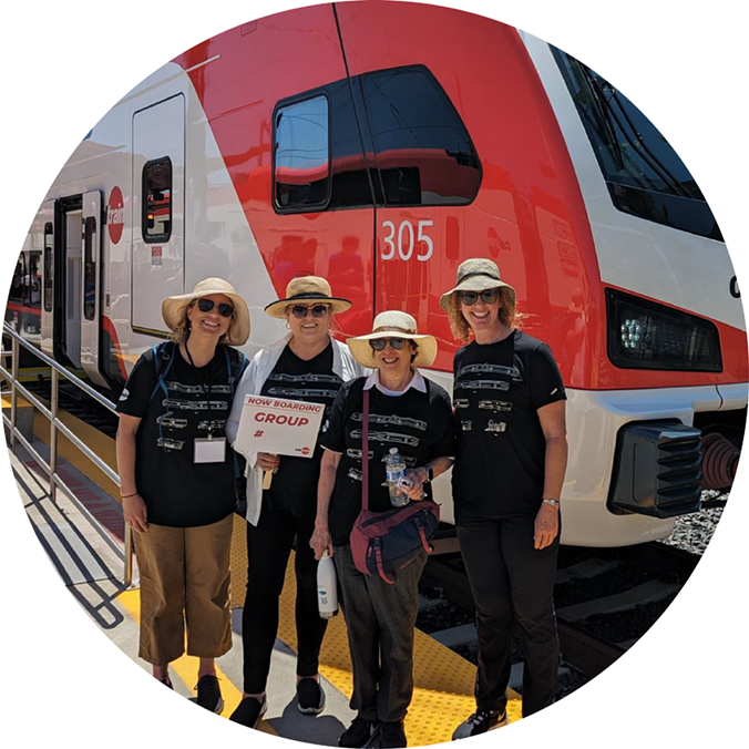 Circlepoint staff stand in front of the new train at an outreach event for Caltrain. 